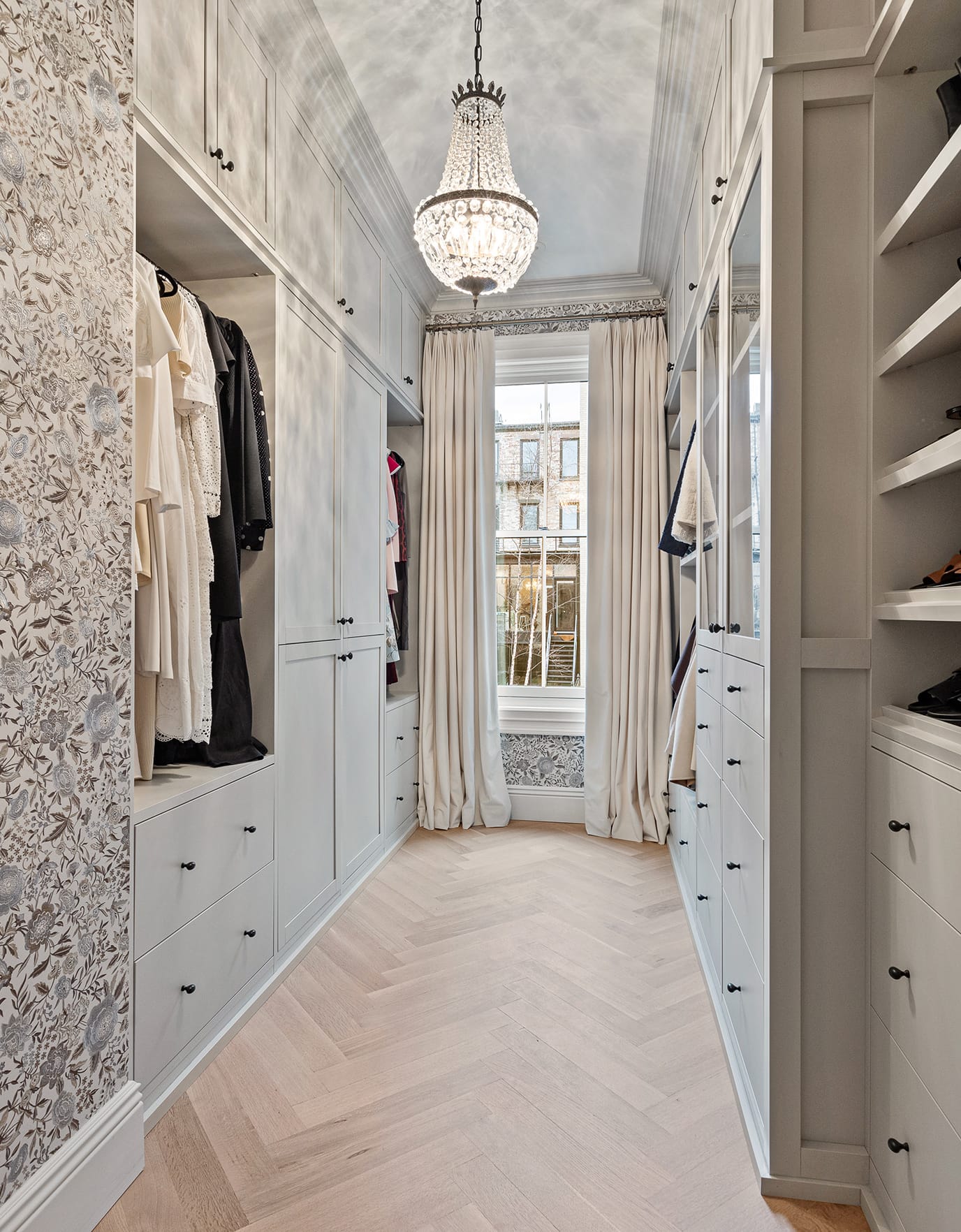 Marina Cheban's customized walk in closet with built in shelving and cabinets in a light wood finish by California Closets